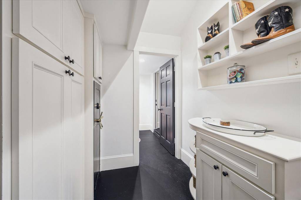 Mud Rom with cabinetry and safe.