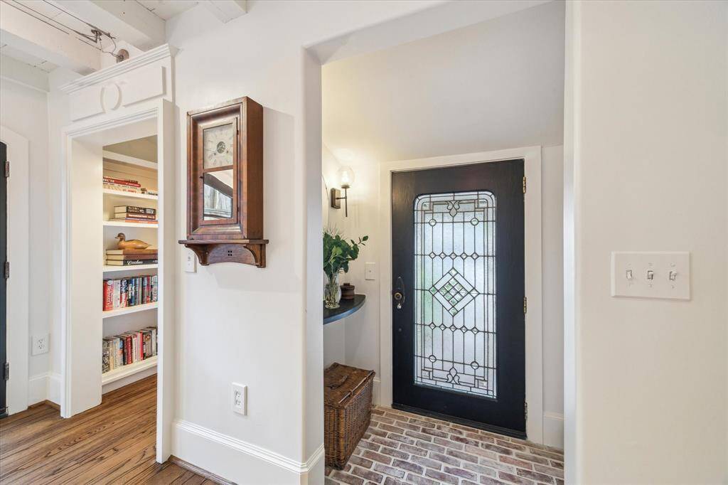 Another view of the front door, brick entry way and inset shelf. One gets a peak at the library nook!
