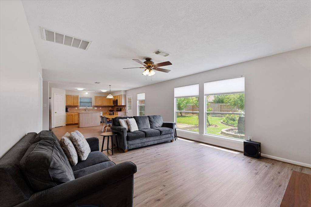 Living room that is open to the kitchen & gives you the views to the lush, landscaped backyard.