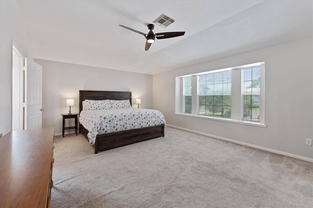 This primary suite is HUGE! Updated carpet, ceiling fan & paint. This room can accommodate large pieces of furniture.