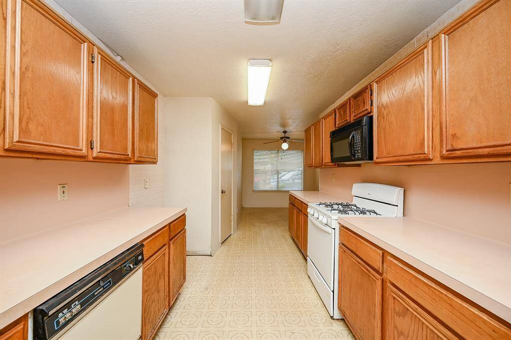Another view of the Kitchen shows the great storage space available, as well as lots of counter space.  There is also a walk in pantry.