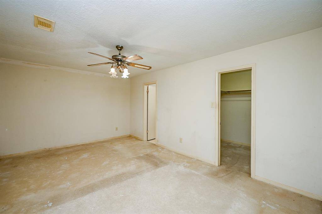The Primary Bedroom is on the opposite side of the house so there is a lot of privacy - in the back off of the Family Room.  It needs some paint and carpet, but is spacious and has a HUGE walk in Closet!