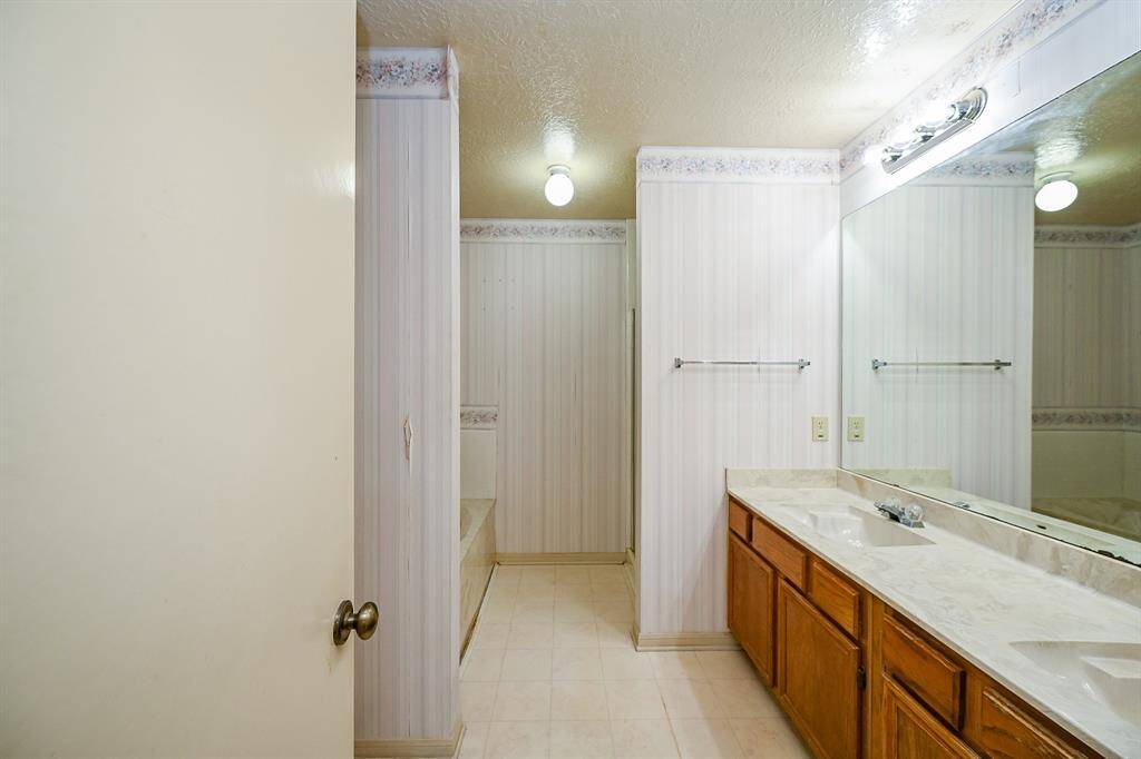 The Primary Bath features double sinks, large counter area, oversized tub and a separate shower - just update it and make it your own spa-like retreat!