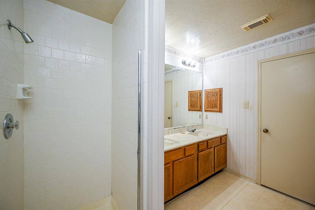 Across from the tub is a separate shower!