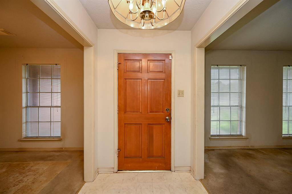 From the moment you enter, you can see the potential. There is a Formal Living Room & Dining Room on each side as you enter and lots of natural light with large windows.