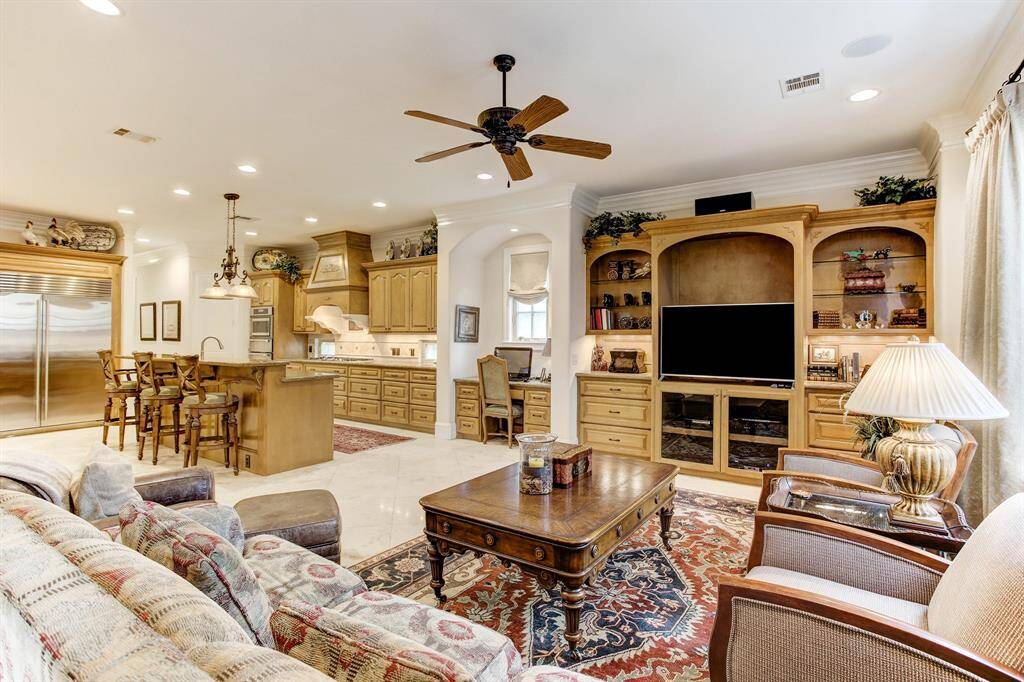 A view of the family room with built-in entertainment center and nice work station to the left with a window.