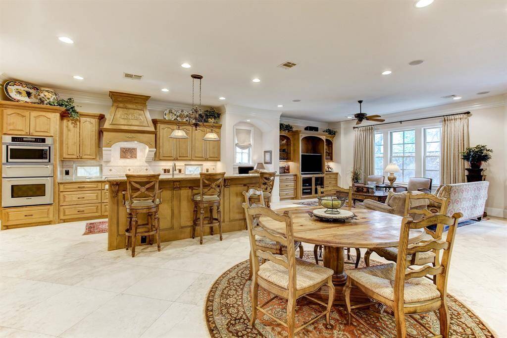 An overall photo of the gourmet kitchen, breakfast area and family room beyond.