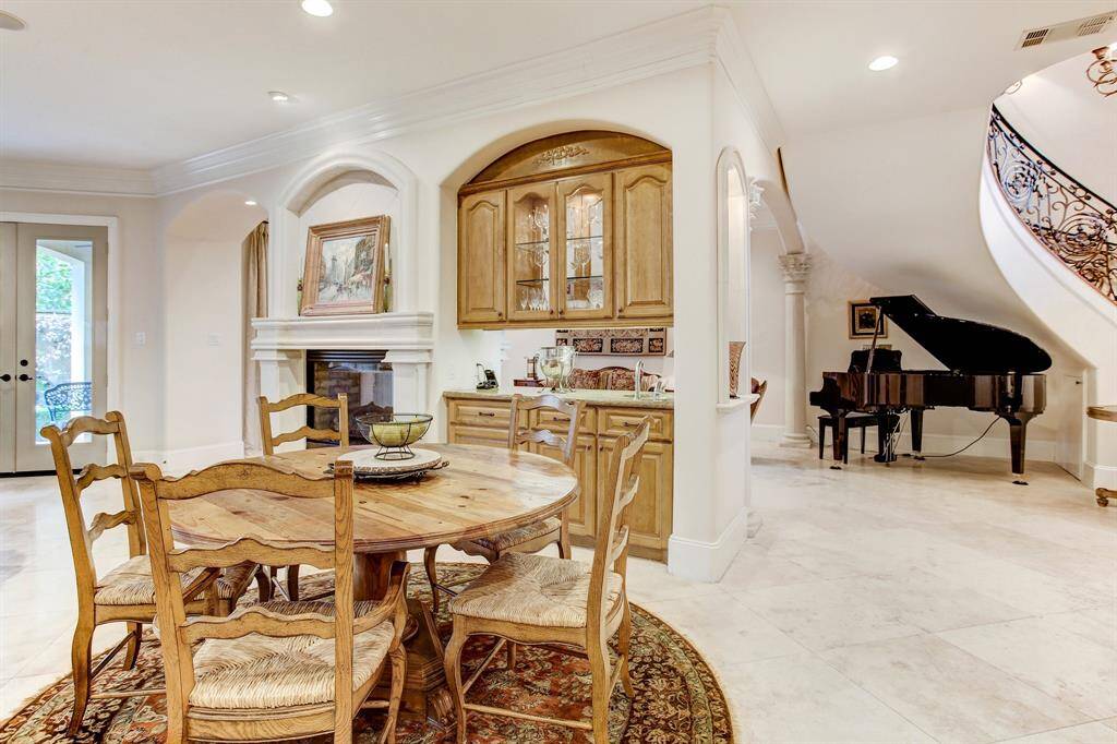 Close up of breakfast area, wet bar, fireplace and French doors to courtyard.