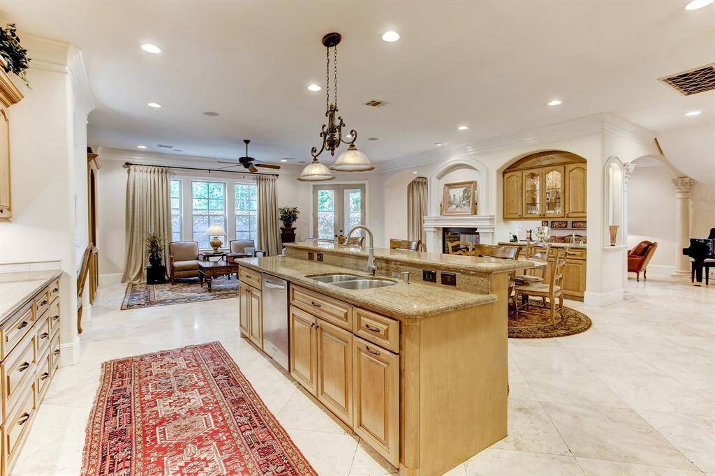 Another wide angle photo of the kitchen and family room with views of the courtyard.