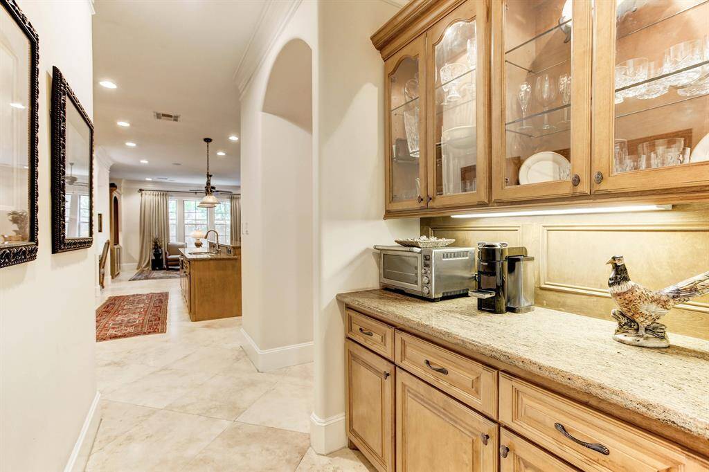 The butler's pantry is conveniently located beyond the kitchen and is very accessible to the dining room.  Lots of glass cabinet storage as well as lighted counter storage.