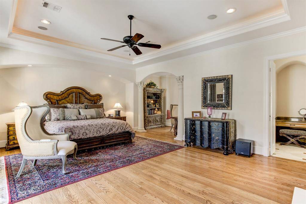 The primary retreat has hardwood floors and raised ceilings, bonus sitting room and a fireplace not shown in this photo.