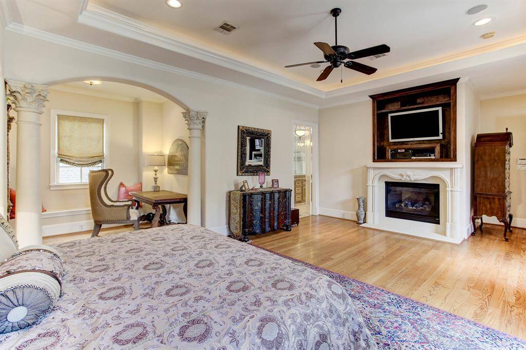 Another photo of the primary bedroom showing the bonus area and fireplace.  The primary bath is to the left of the fireplace.