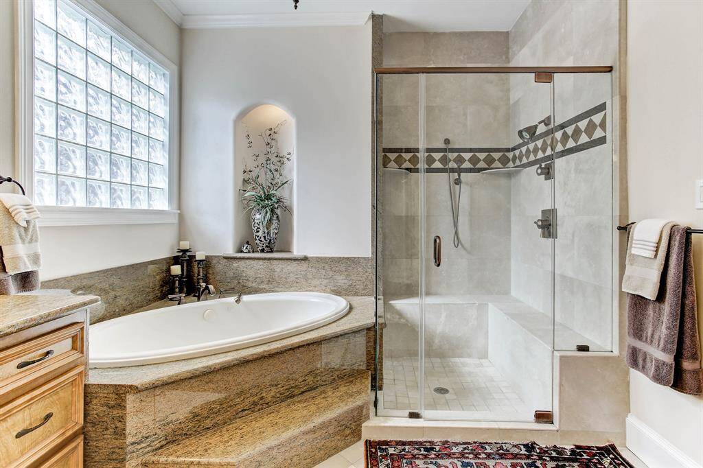 Another photo focusing on the granite soaking tub and shower.