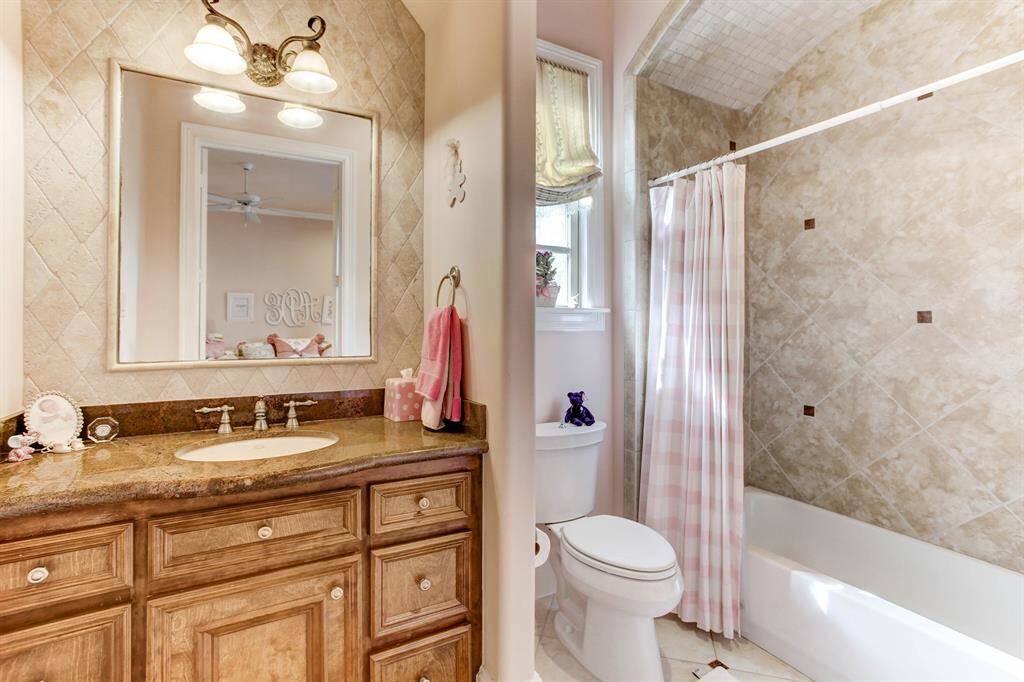 Another secondary bath with tub and shower head.