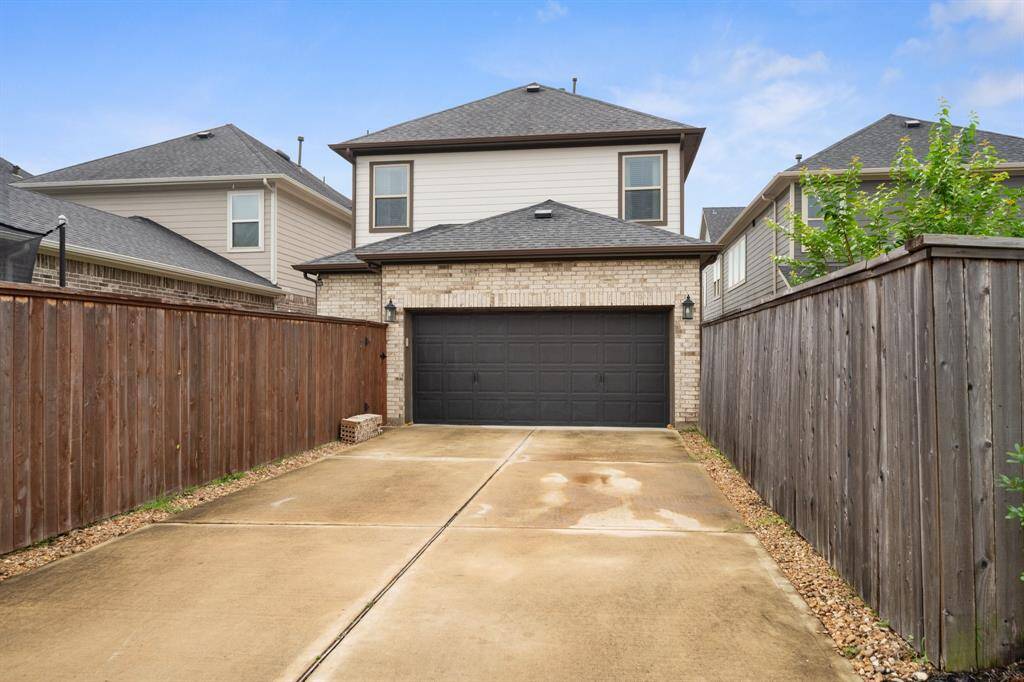 The spacious 2-car garage, conveniently located at the back of the house, features a double-wide driveway, providing ample parking and easy access.