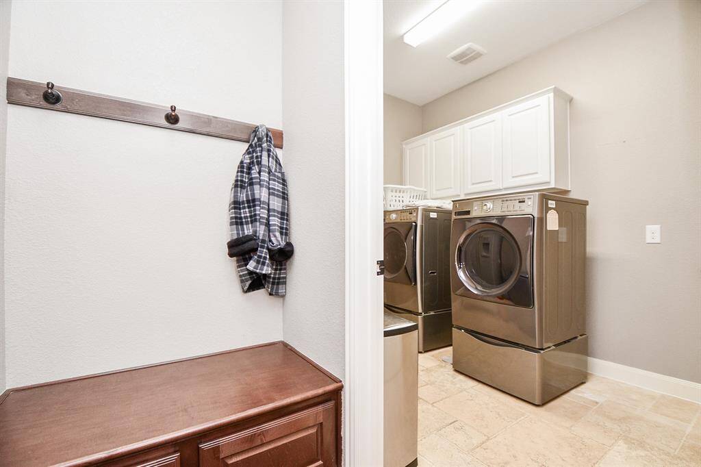 The mud room has storage space and leads to the laundry room.