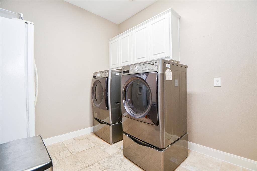 The laundry room features tile floors,washer and dryer connections, andplenty of storage space.
