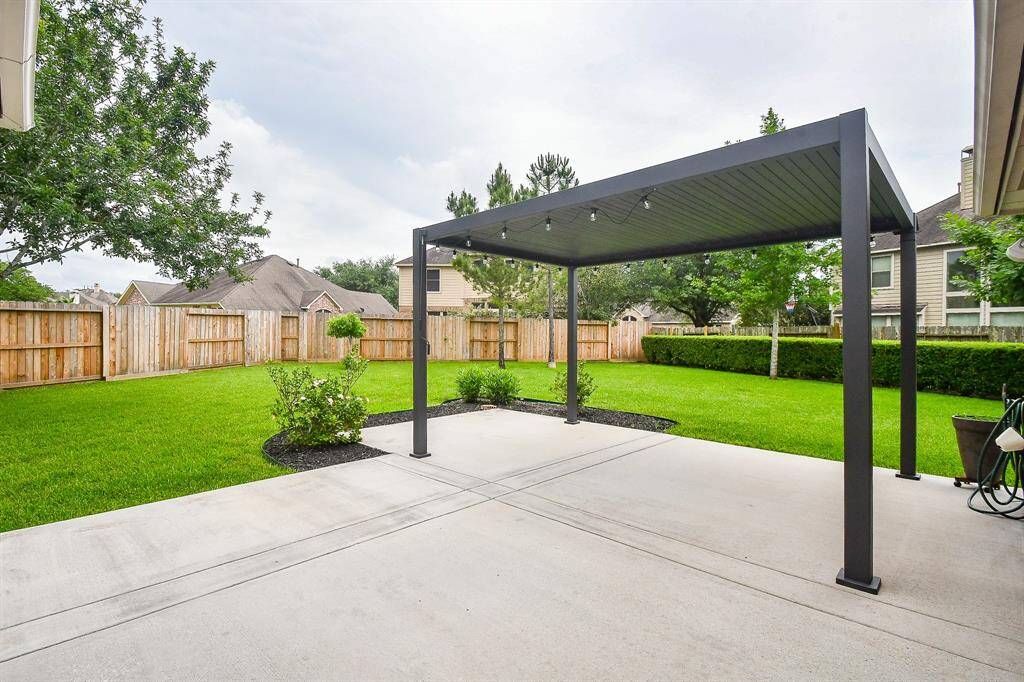 Let's head on outside to your INCREDIBLE backyard! You'll love the extended patio with a charming pergola—perfect for relaxing in the shade, grilling on the weekends, or hosting outdoor gatherings.  Thoughtful and lush landscaping and 2 sides of fence are new!