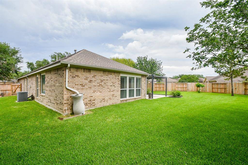 This will be your new ideal spot on this ENORMOUS patio space for morning coffee, evening chats, or enjoying the breeze while overlooking your spacious yard.