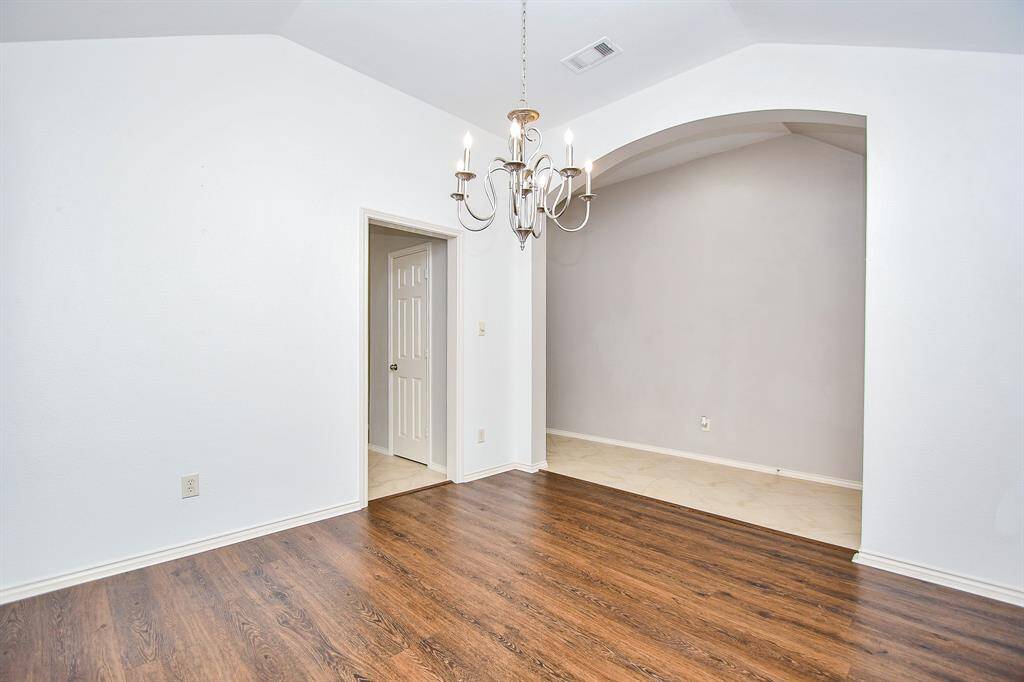 Immediately to the left of your entryway is your dining room complete with two large windows impeccably dressed with custom shutters, making it a bright and welcoming space perfect for family dinners or festive gatherings. This photo is virtually staged.