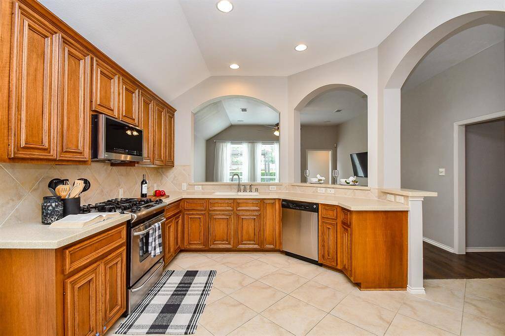 Your kitchen is thoughtfully connected to the dining room, creating an effortless flow for both everyday meals and hosting. Whether you're serving lunch for family or entertaining guests, everything is just steps away for maximum convenience. This photo is virtually staged.