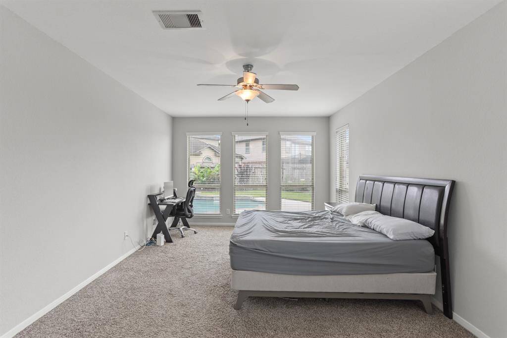 Unwind after a long day in this incredibly spacious Primary Bedroom! Featuring lots of natural light, plush carpet, privacy blinds, and a ceiling fan.