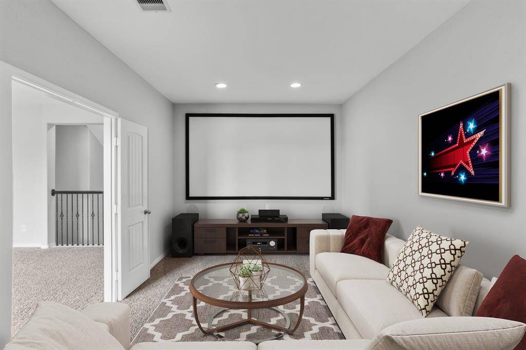 Virtually Staged: No need to go to the movie theater with this fantastic media room! It is complete with plush carpet and recessed lighting.