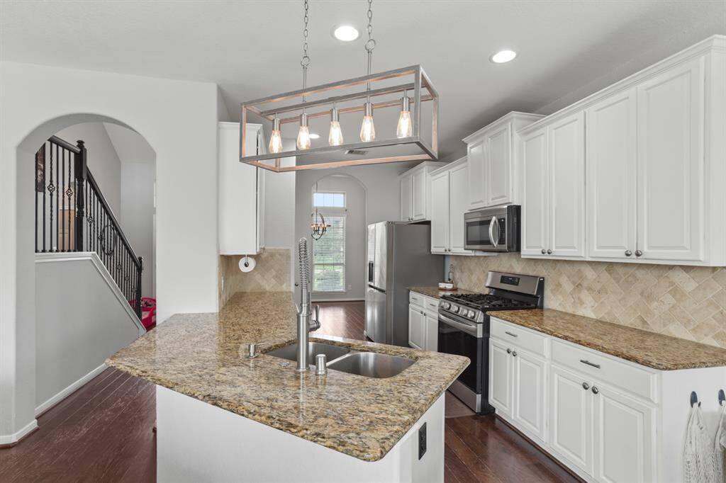 Host your next dinner party with confidence! This masterfully-equipped kitchen features a kitchen island, an abundance of cabinetry and hardware, TONS of counter space, granite countertops and stainless-steel appliances.