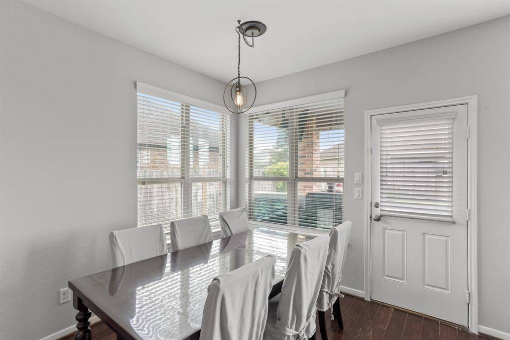 Charming breakfast area, complete with wood floors, and beautiful views of the backyard provided by several windows with privacy blinds.