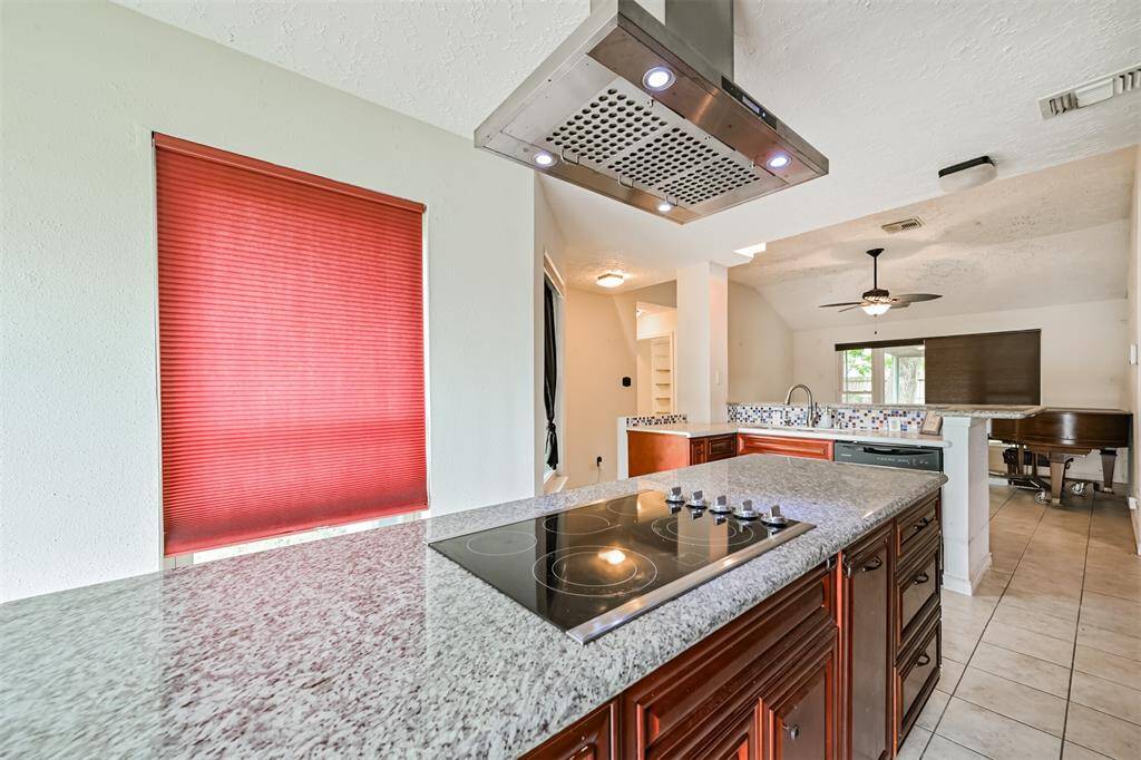Chef's eat-in island kitchen features custom cabinets, lengthy countertops, stainless steel appliances and a breakfast bar