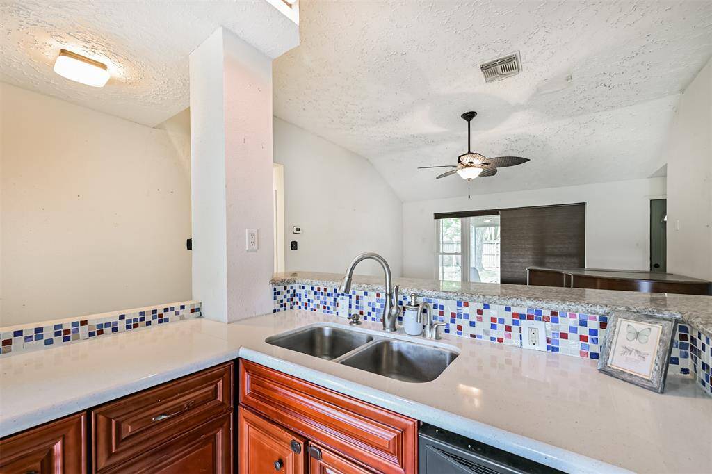 Chef's eat-in island kitchen features custom cabinets, lengthy countertops, stainless steel appliances and a breakfast bar