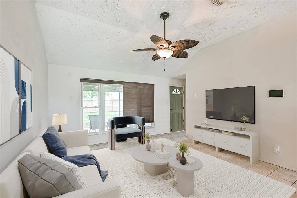 Living room open to the kitchen features high ceilings
