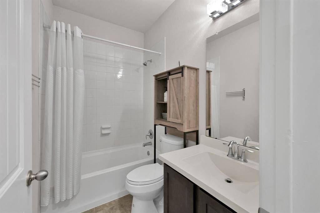 The secondary bathroom has an updraged vanity light. The bathroom has been kept clean and maintained.