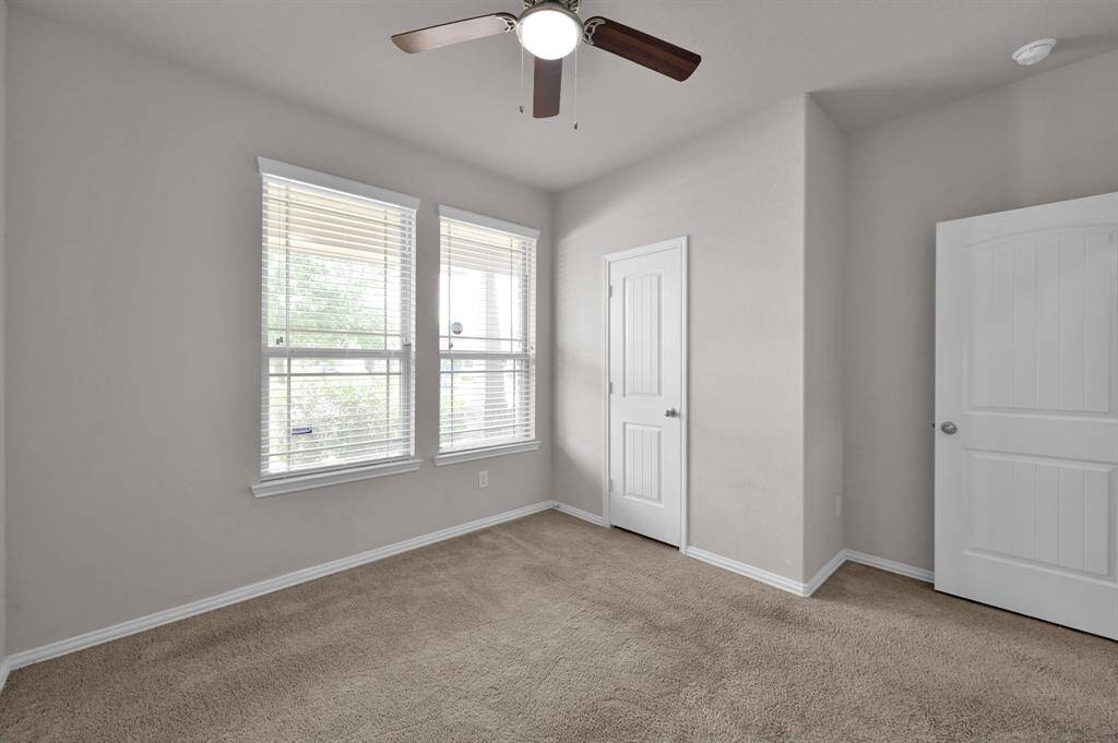 An additional view of the secondary bedroom located in the front of the home. Look how clean everything is... even the carpet!