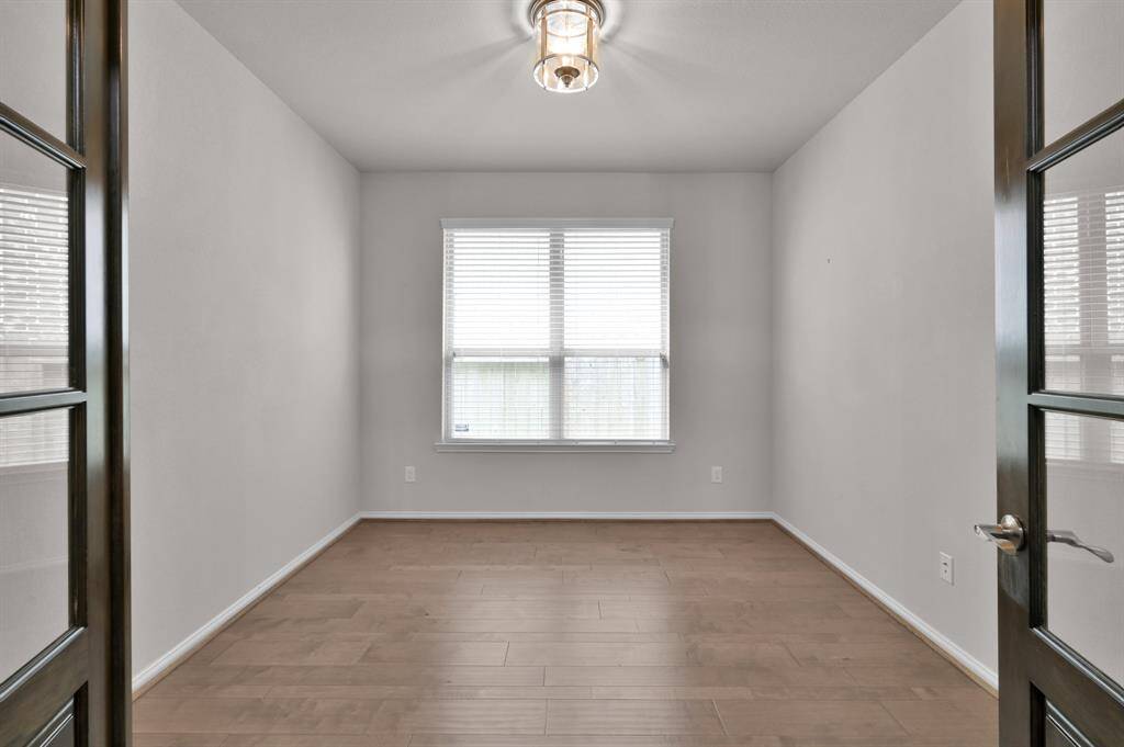 Large home office/ flex room with updraded light fixture and custom doors.