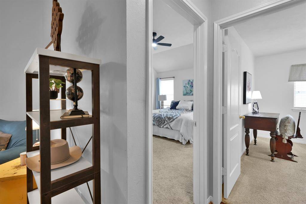 Doorway to the left is the primary suite and to the right a secondary bedroom