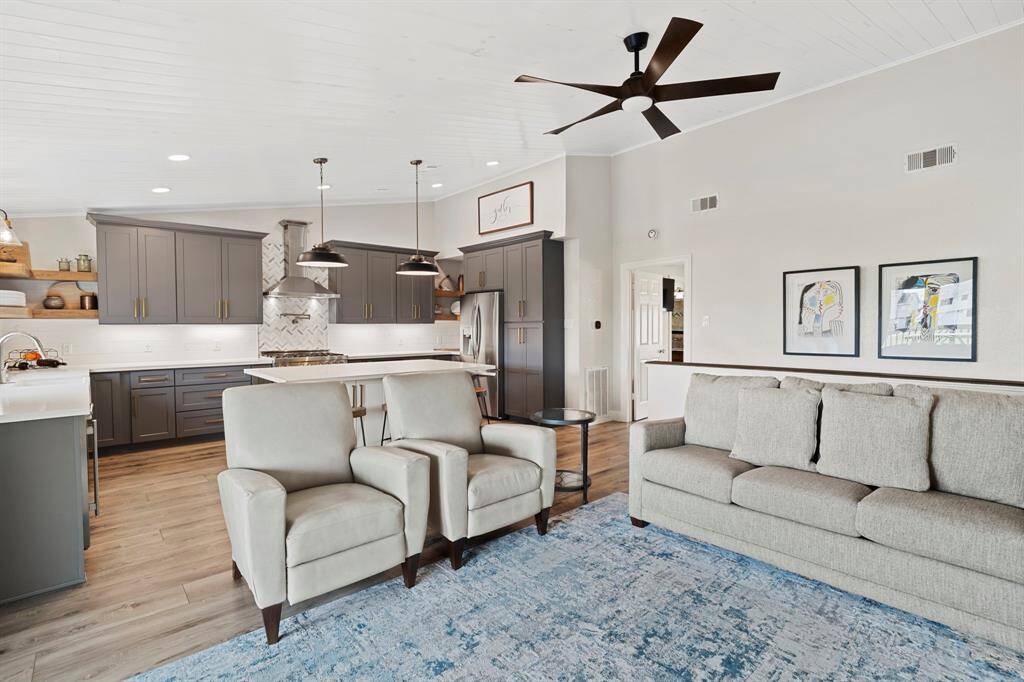 Open-concept kitchen and living room create a seamless, airy space ideal for everyday living and entertaining.