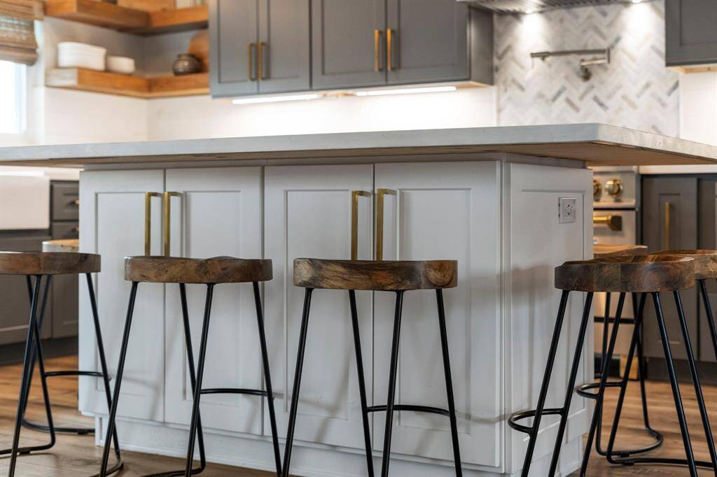 Spacious center island with breakfast bar and built-in storage, comfortably seating up to 10.