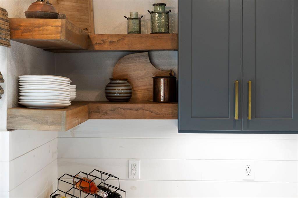 Natural wood open shelving (installed 2022) in the kitchen brings warmth and a cozy vibe, and the open design keeps things accessible and airy.