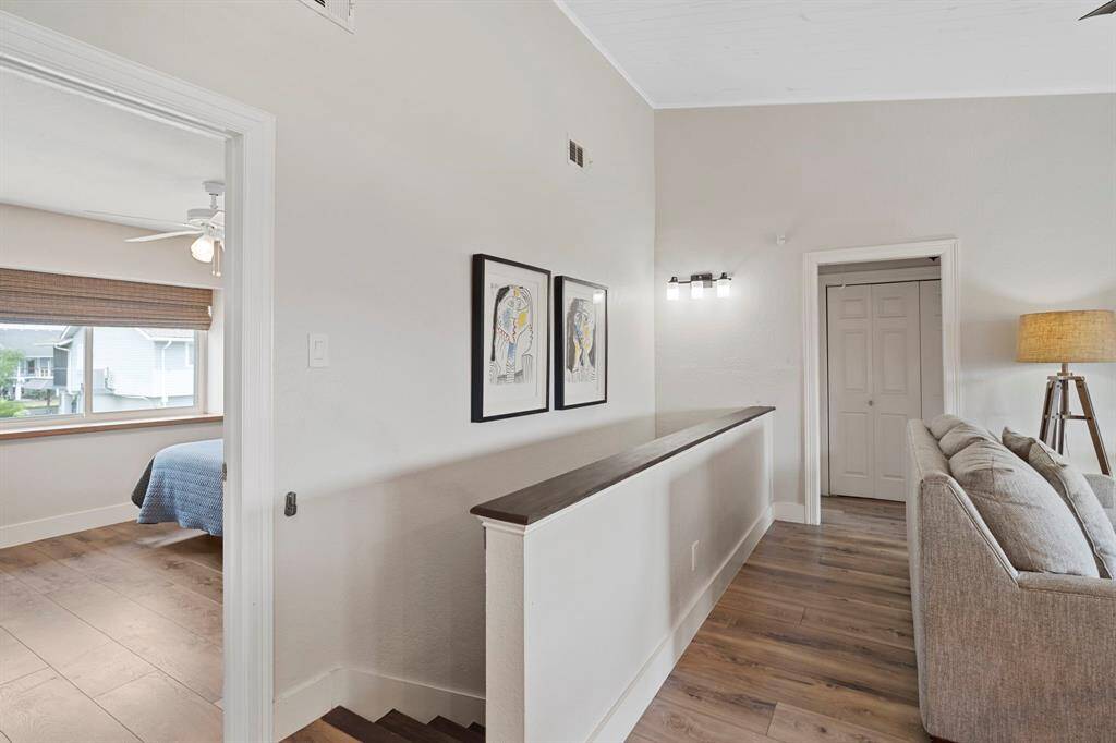 A staircase pony wall keeps the space light and bright, maintaining an open feel while still providing subtle separation.