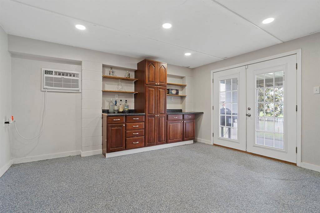 The Game Room features elegant custom built-ins that make a stylish cocktail bar.
