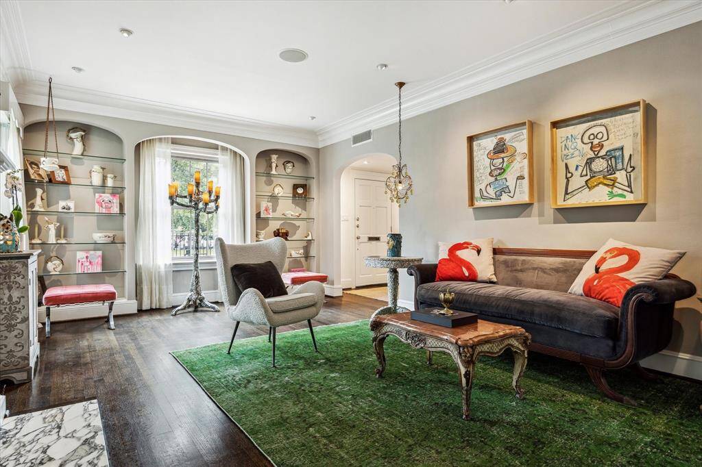 Playful artwork and sculptural accents bring energy and personality to the room, while French doors invite a seamless connection to the outdoors.