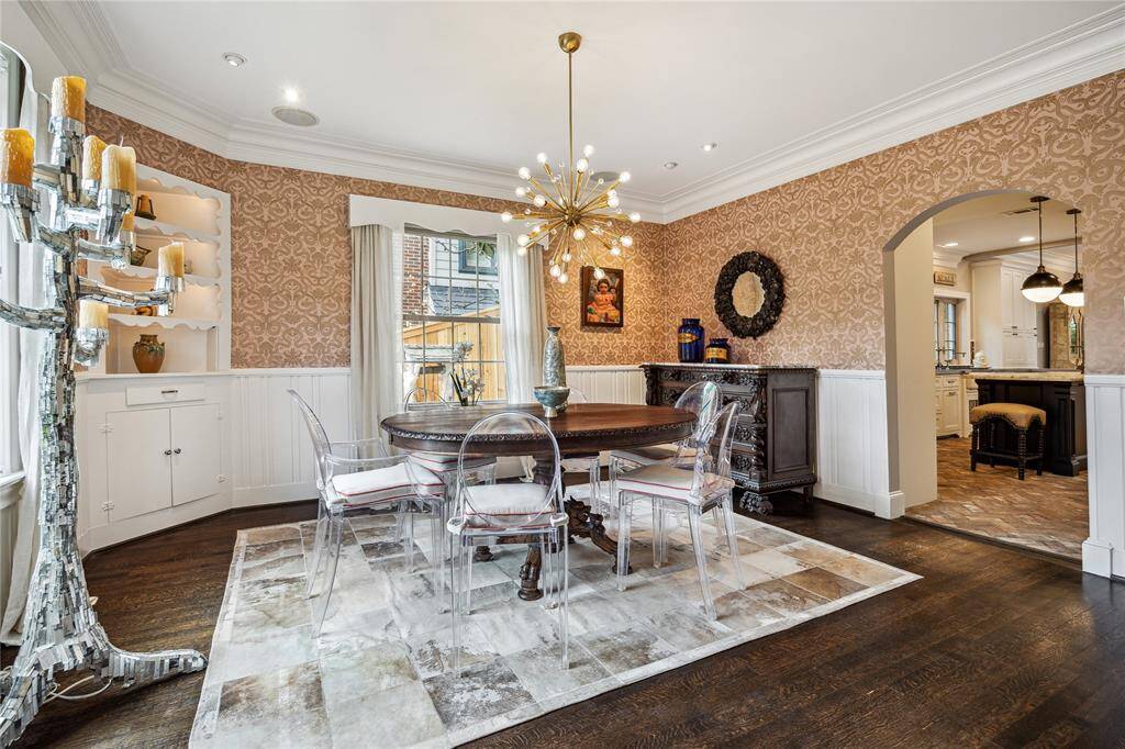 Statement lighting, custom millwork, and vintage accents create a space designed for both grand dinner parties and quiet conversation.