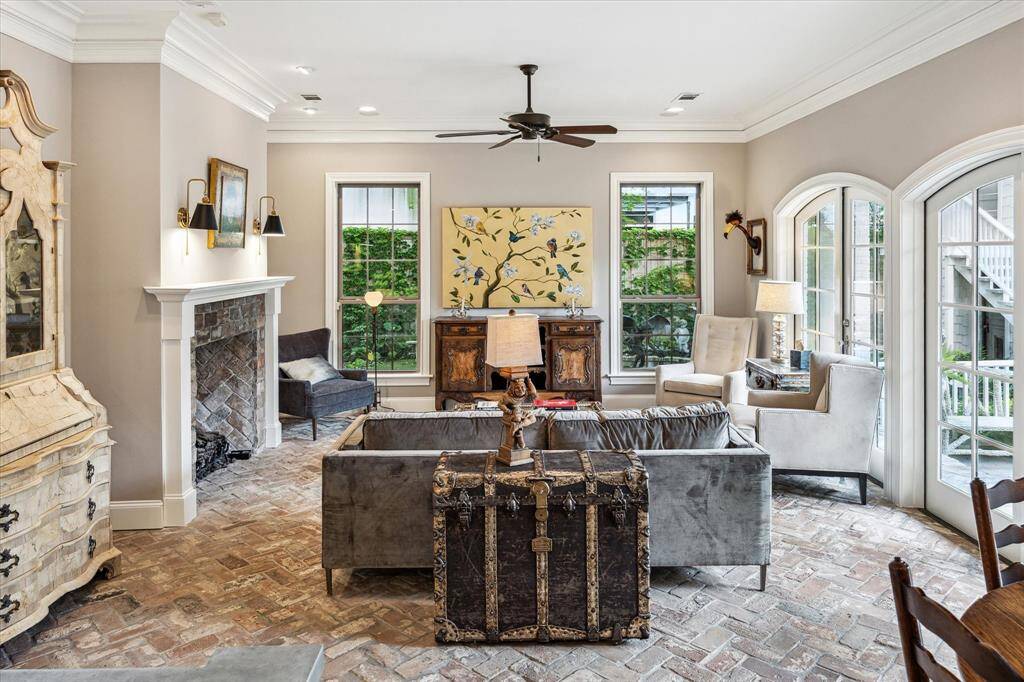 This light-filled sitting area offers a peaceful pause between the home’s more formal spaces. Neutral hues and subtle architectural details create a calm, effortless elegance—perfect for unwinding or quiet conversation.