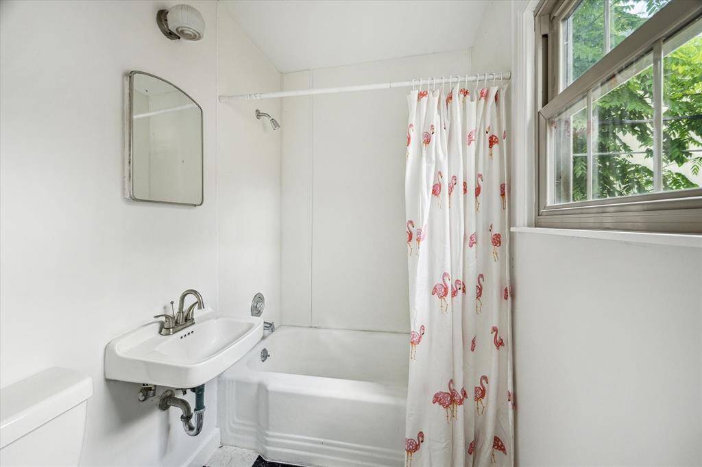 This large open room offers endless possibilities—whether used as a guest suite, home office, or creative studio, it’s filled with natural light and hardwood charm.