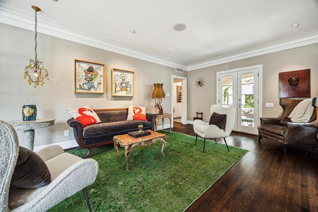 Wood cased doorways and natural light lend a sense of openness, while curated details offer a perfect backdrop for both relaxation and entertaining.
