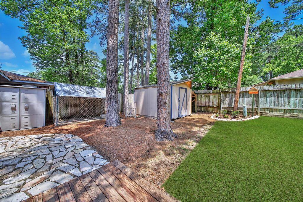 View of stone patio area in the backyard.