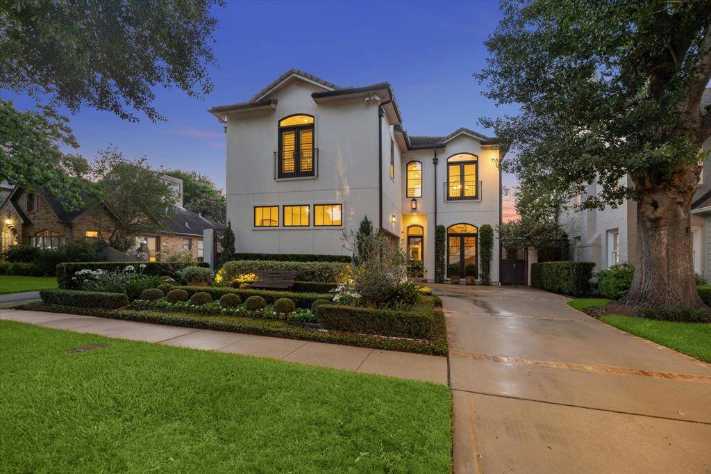 Stunning curb appeal with manicured landscaping, architectural symmetry, and custom lighting—an elegant introduction to this thoughtfully designed home.