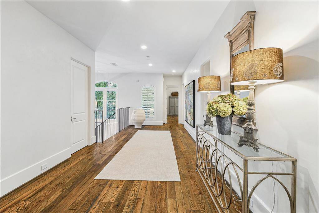 Spacious upstairs landing with hardwood floors and natural light—ideal as a second TV room, sitting area, or reading nook.