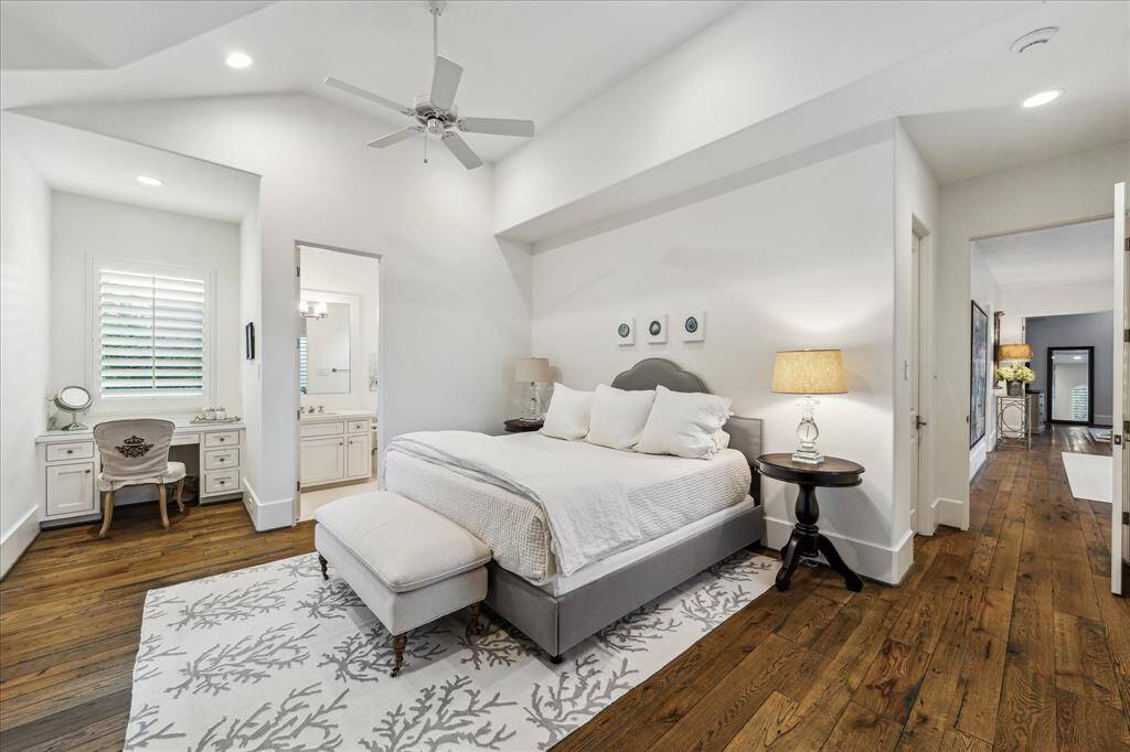 Spacious ensuite bedroom with vaulted ceilings, built-in vanity and full bath.